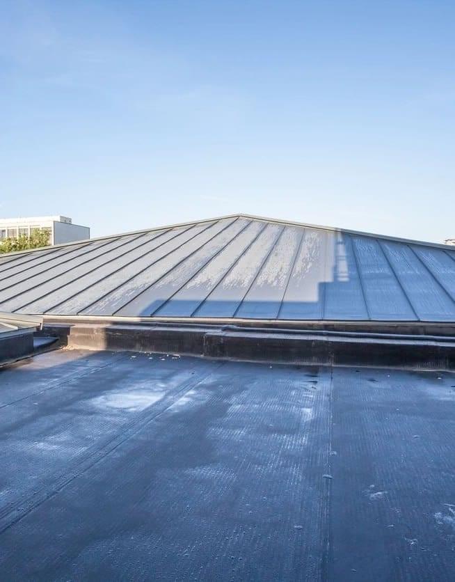 Metal roof with clear blue sky background.