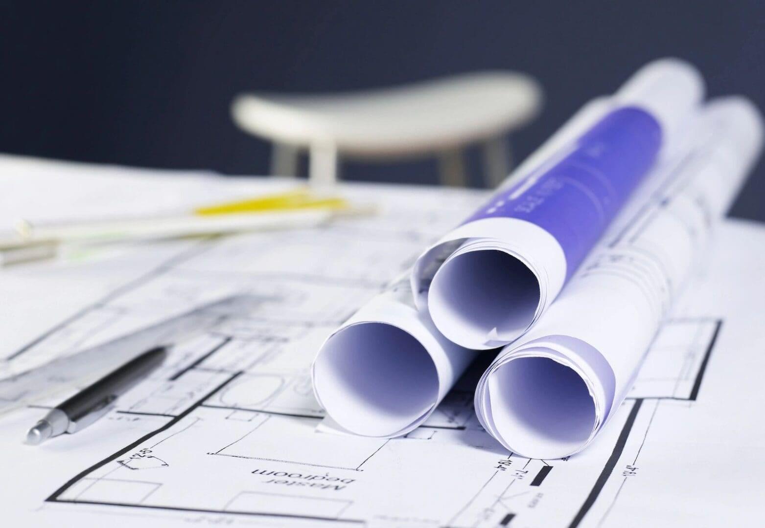 Rolled blueprints on architectural plans.